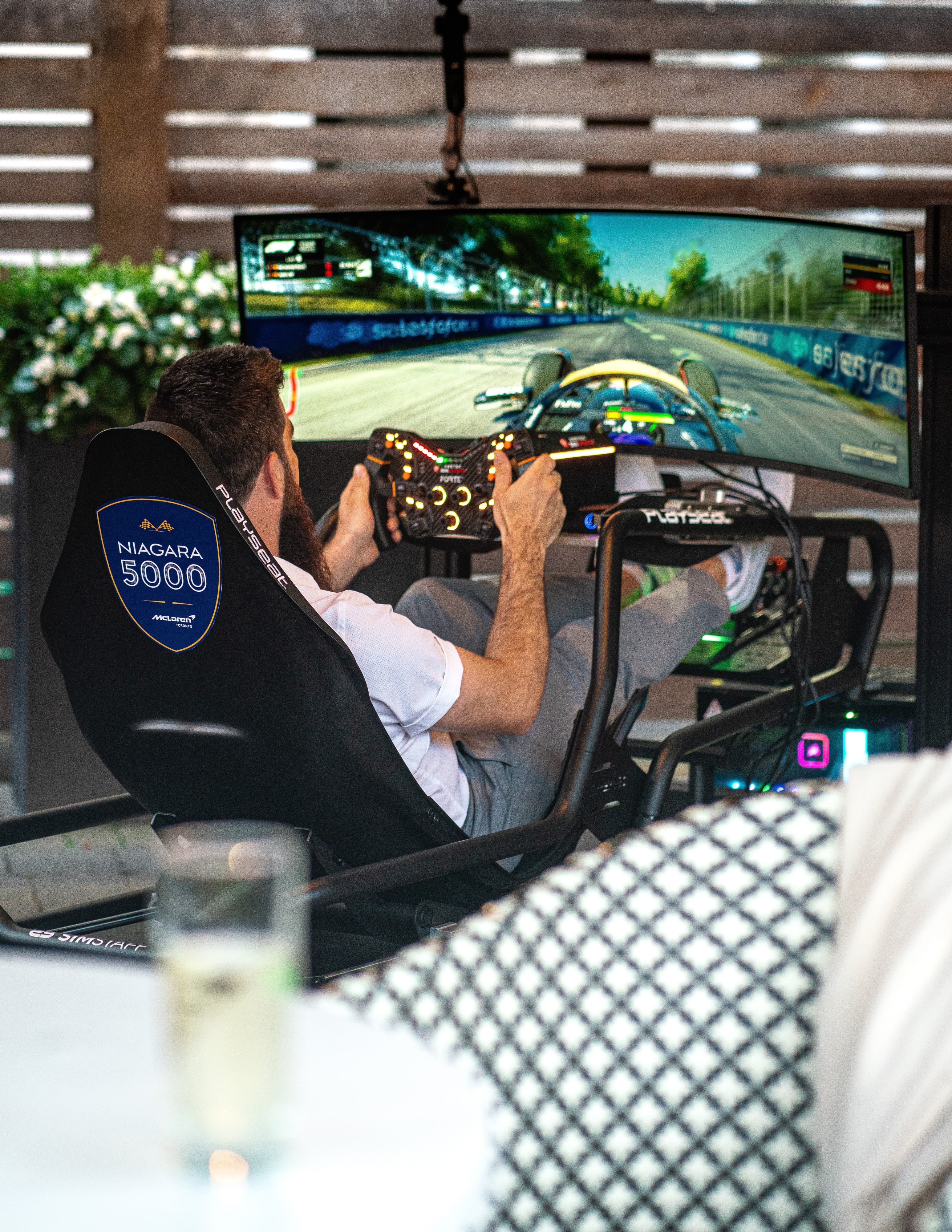 Guest driving a Niagara 5000 branded F1 racing simulator